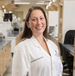 Head shot of Fernanda Priviero, Ph.D. in lab