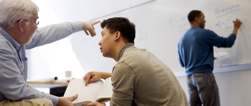 Professor with 2 students in classroom