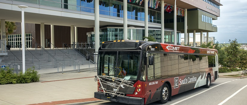 Cocky stands proudly in the doorway of a USC shuttle.