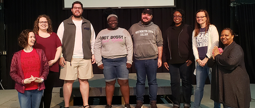 A diverse group poses while on a diversity retreat. 