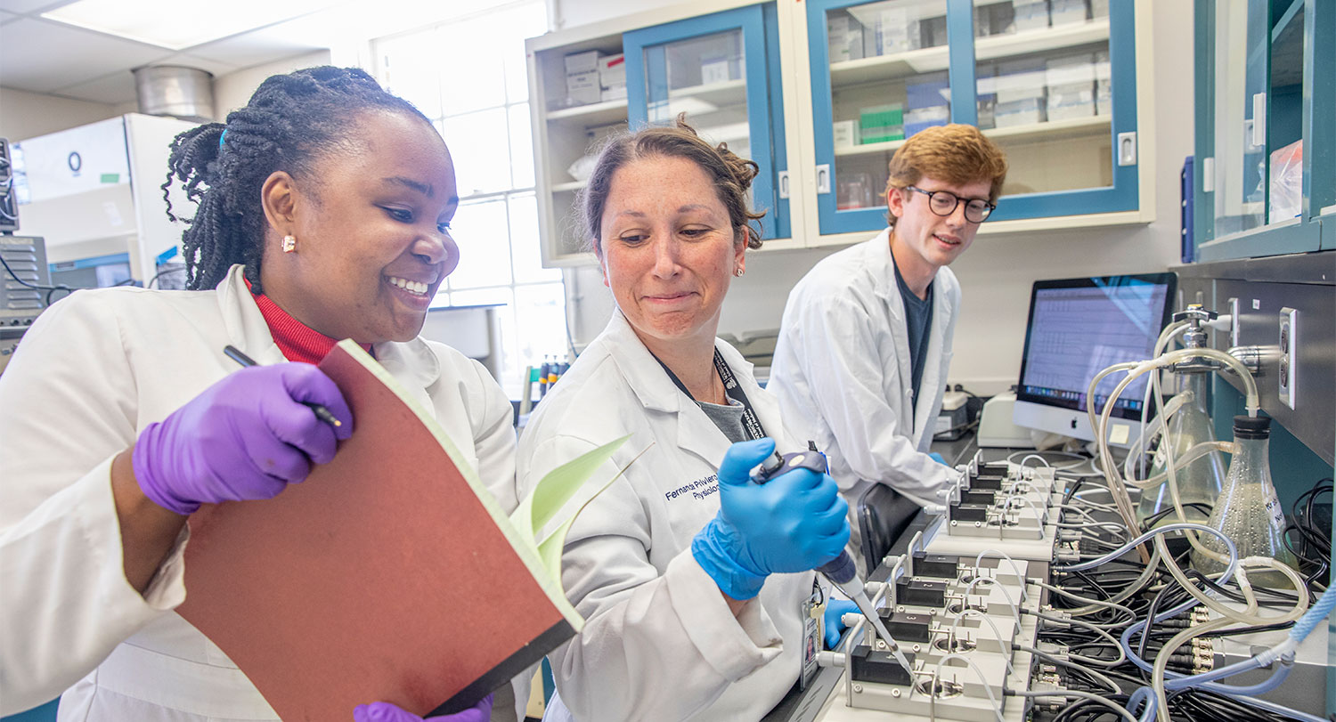 Three researchers working together in a lab.