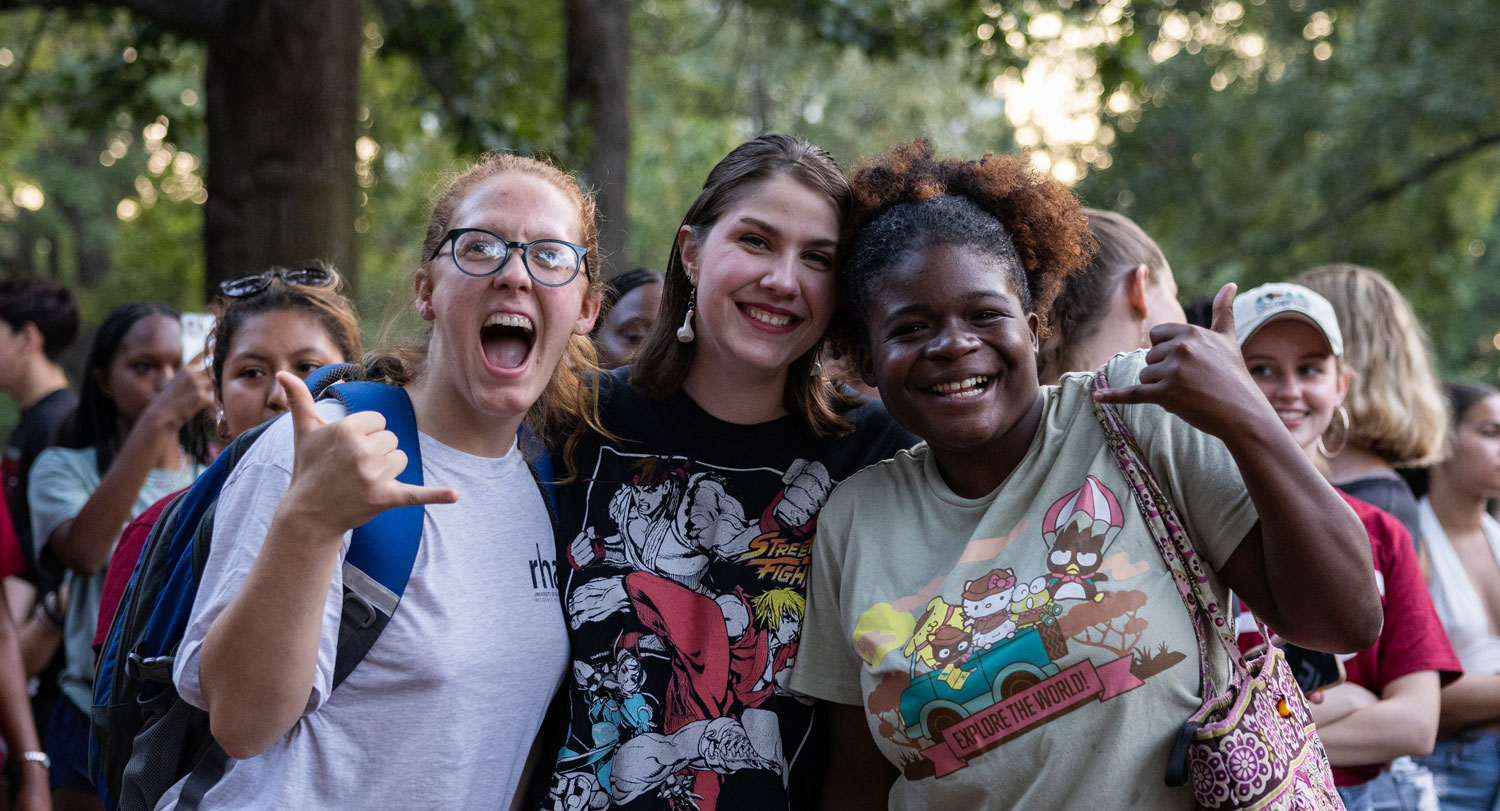 Group of students smiling for the camera at an event on the Horseshoe. 