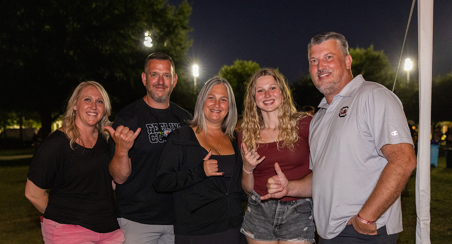Family posing together at the Family Weekend Tailgate. 
