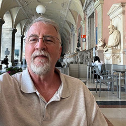 Paul Allen Miller, a gray haired caucasian male, smiles.