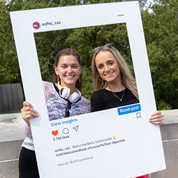 two girls posting in instagram photo