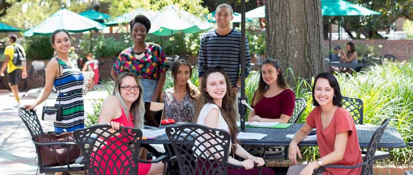 Students sitting outside at a table