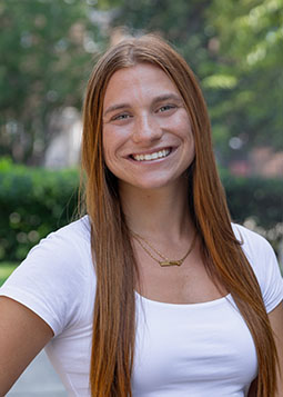 Smiling redheaded woman in white top