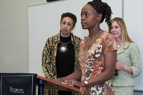 Dr. Daniella Ann Cook of the Department of Instruction and Teacher Education introduces Dr. Millicent E. Brown Monique Travelstead Mcnamara is in the background.