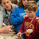 Youth participating in a ground layer underasphalt demonstration