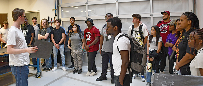 Student giving tour to a group of prospective students and their parents