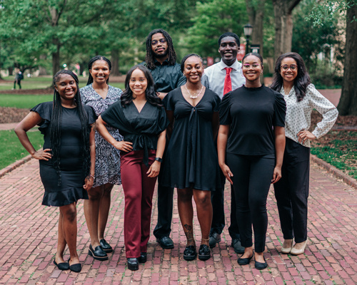 A group of young black students posing on USC's Historic Horseshoe.