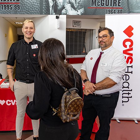 Representatives from CVS Health speak with students a Experience Expo.