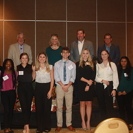 A group of HRSM student pose for a photo with executives from Innisbrook Resort in Palm Harbor, Fla., during a site visit to the organization in November 2022.