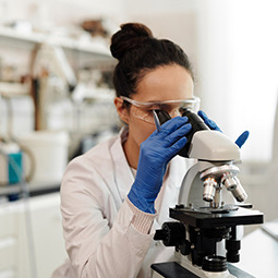 Woman at a microscope