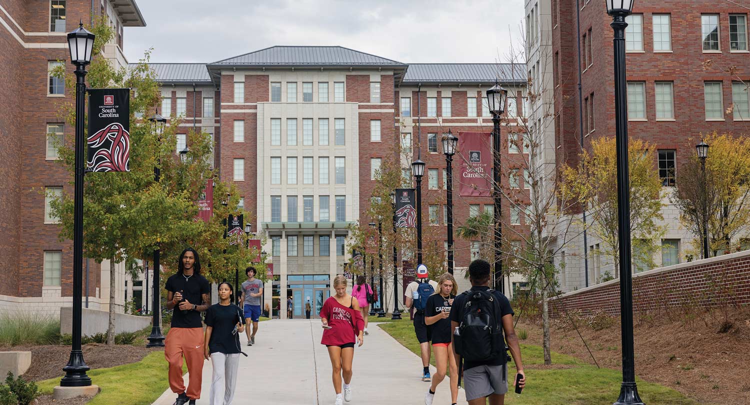 Campus Village with students walking on the surrounding sidewalk.