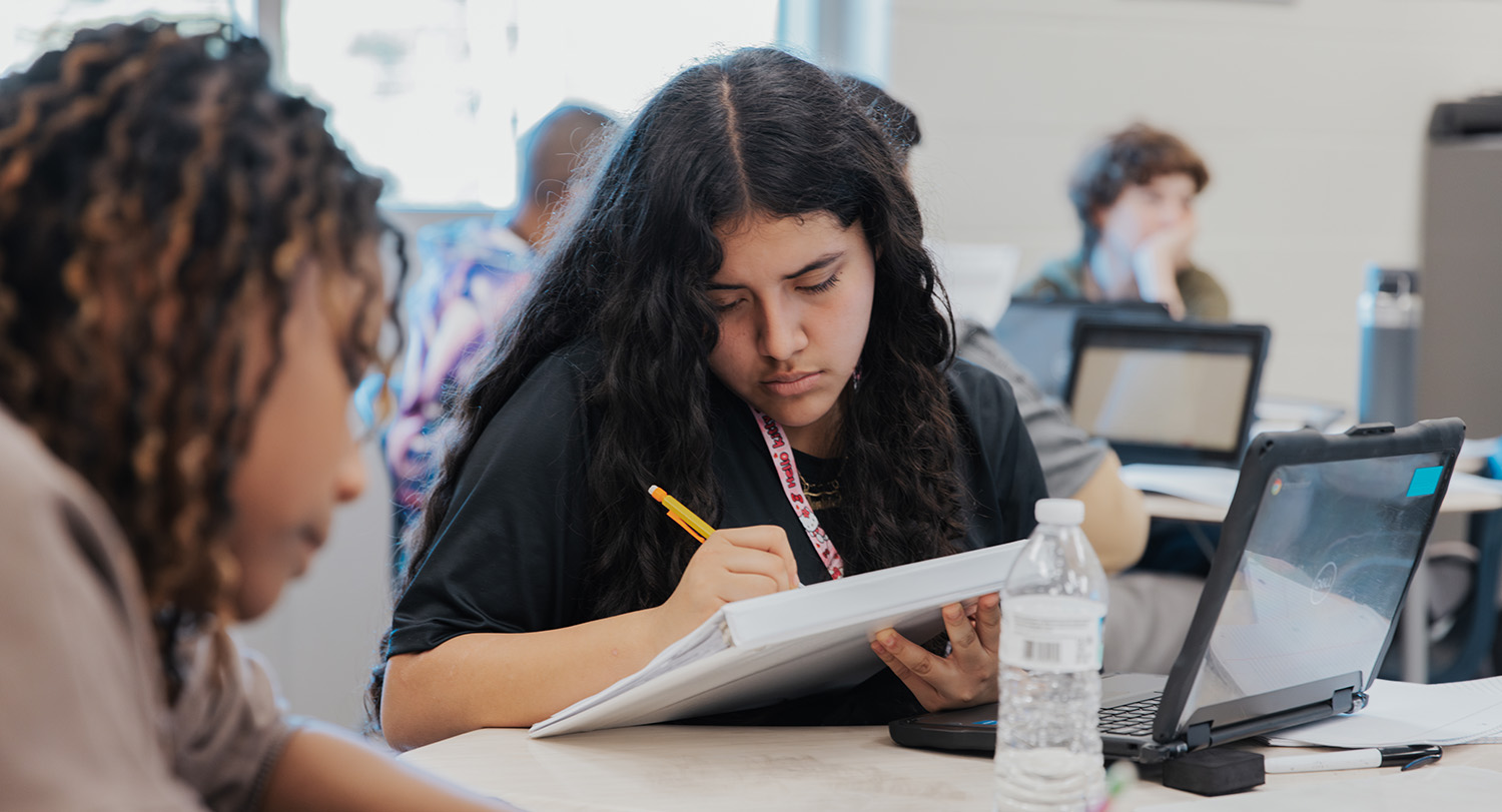 Student taking notes in class