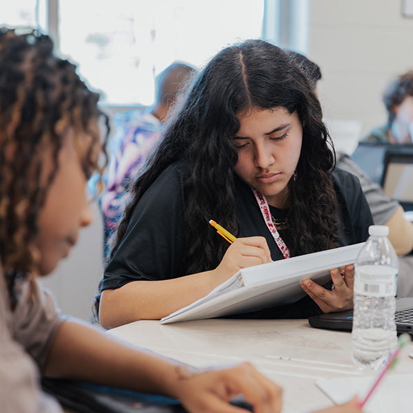 Student taking notes in class