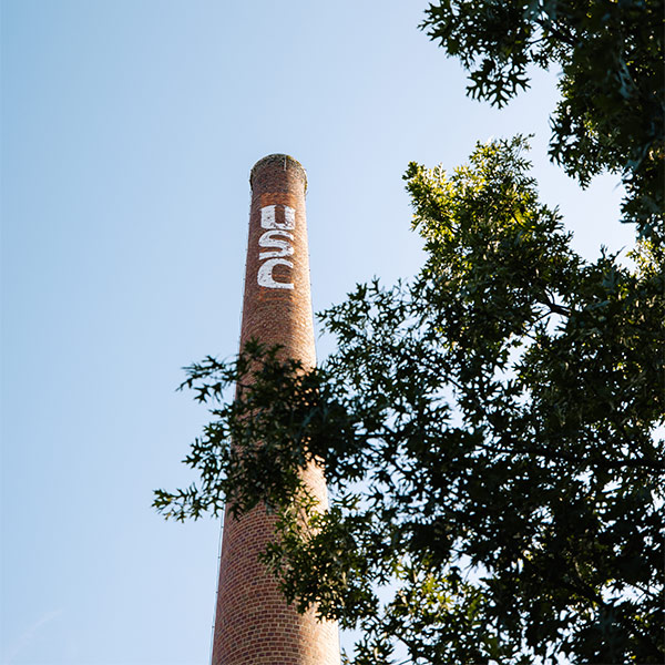 photo of brick smokestack with USC written in white letters