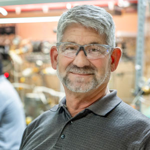 a man wearing safety glasses stands in a lab