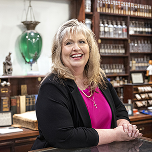Kathy Moore poses inside the College of Pharmacy museum.