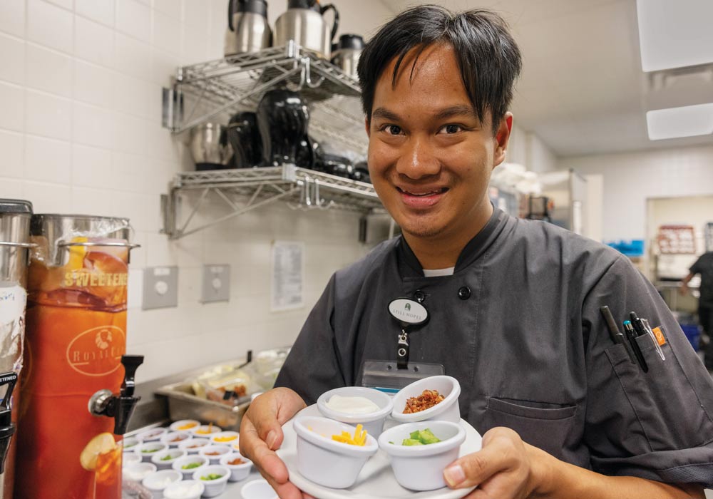 Andro Keck helps prepare dinner in the Still Hopes kitchen.