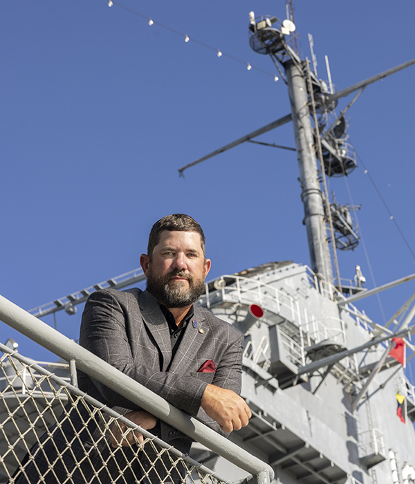 Jay Alverson poses with a ship in the background.