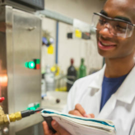 Student takes notes in experiment